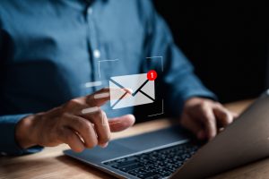 Businessman sending email by laptop computer to customer, business contact and communication, email icon, email marketing concept, send e-mail or newsletter, online working internet network.